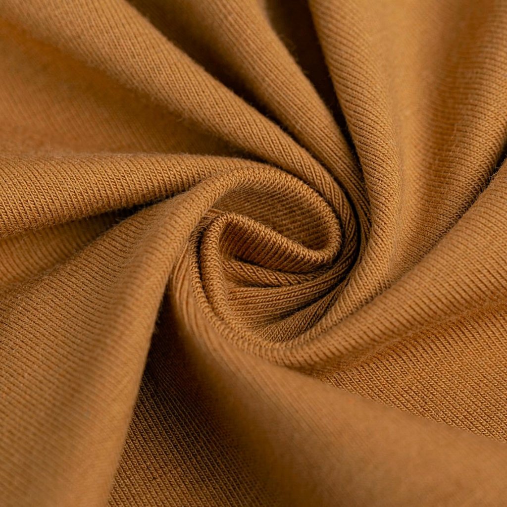 A close-up of soft, brown fabric twisted into a gentle swirl, highlighting smooth knit texture and folds.