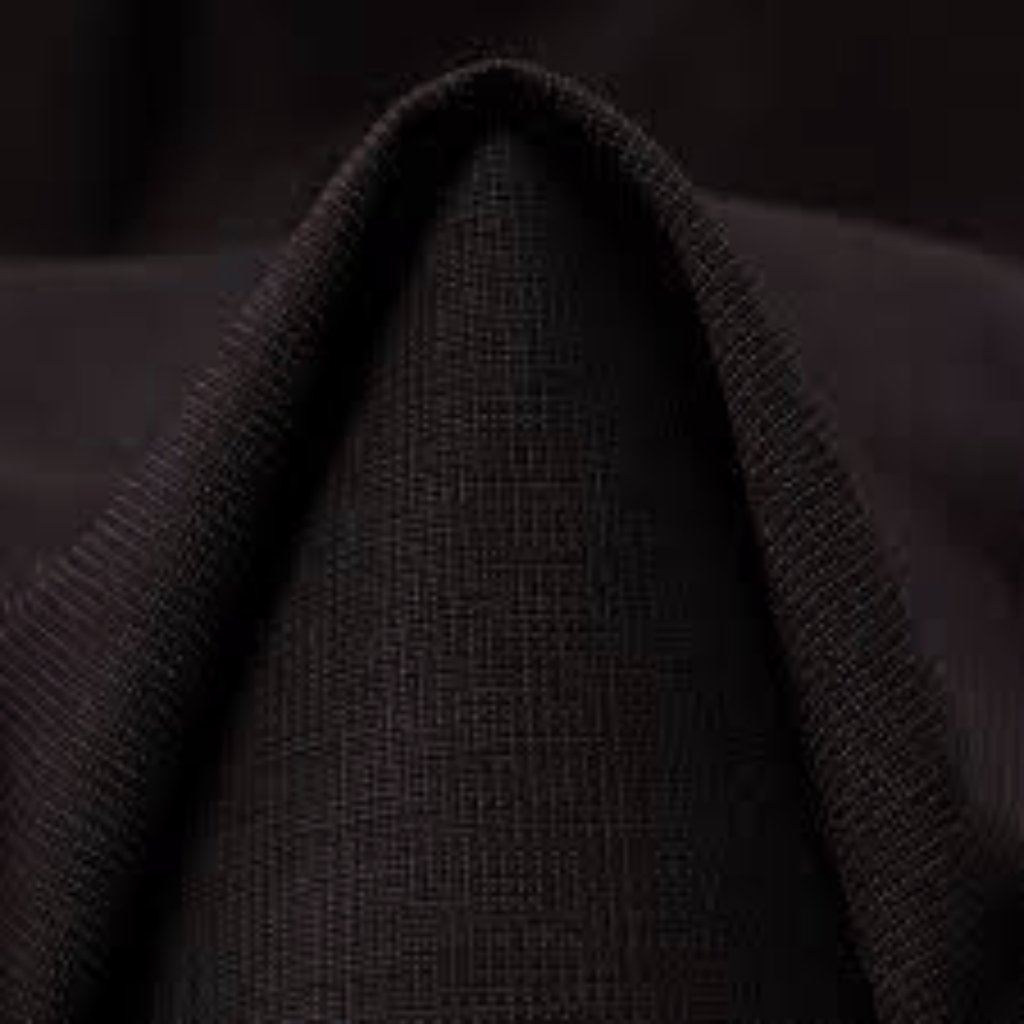 A dark, textured hood or draped fabric forming a subtle peak.