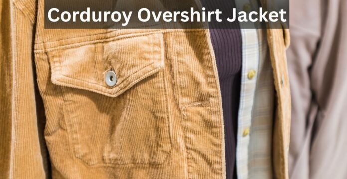 Close-up of a tan corduroy overshirt jacket with a flap pocket and button, layered over a dark knit and a plaid shirt.