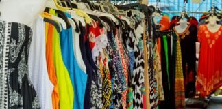 Cotton Dresses for Women – Stylish, Breathable & Comfortable A crowded clothing rack filled with a variety of colorful dresses and tops hanging on hangers. Cotton Dresses