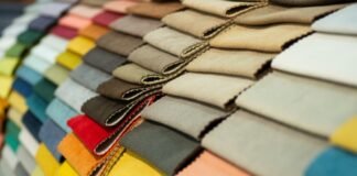 Cotton Fabric for Upholstery, Durable, Stylish & Comfortable Stacked rows of fabric swatches in a spectrum of colors, arranged by shade from bright to neutral. cotton fabric for upholstery