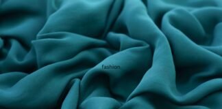 Fashion Rayon Fabric: The Perfect Blend of Style & Comfort A close-up shot of luxurious teal rayon fabric with soft folds and draped waves.