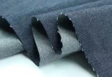 1. What Is Chambray Fabric? A Complete Guide to This Lightweight Textile Close-up of folded blue chambray cloth showing its texture, illustrating what is chambray fabric.