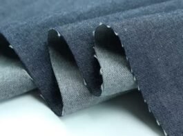 Close-up of folded blue chambray cloth showing its texture, illustrating what is chambray fabric.