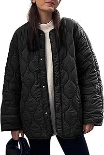 Woman wearing a black quilted jacket with a curved stitch pattern, standing against a light background.