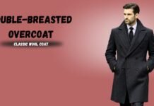 Double-Breasted Overcoat Guide: Style, Fit, and Features Man wearing a dark double-breasted wool overcoat against a muted pink background; text reads 'DOUBLE-BREASTED OVERCOAT' and 'CLASSIC WOOL COAT'.