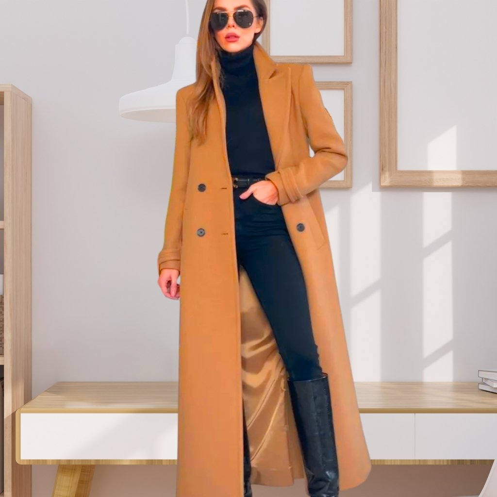 A stylish woman wearing a camel long coat over a black turtleneck and black pants, paired with tall black boots and sunglasses.