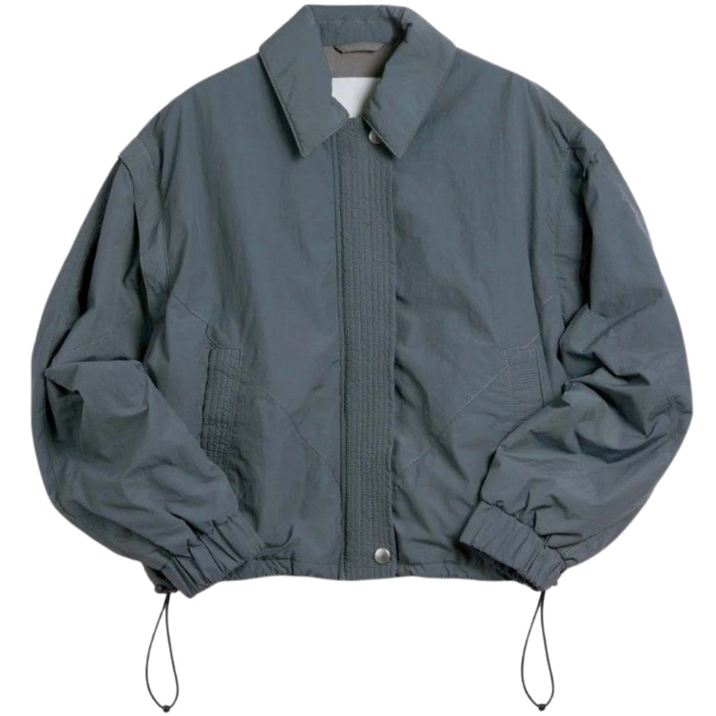 Gray oversized windbreaker jacket with elastic cuffs and drawstrings at hem.