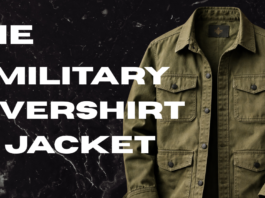 A military-style olive-green overshirt/jacket displayed against a dark marbled background.