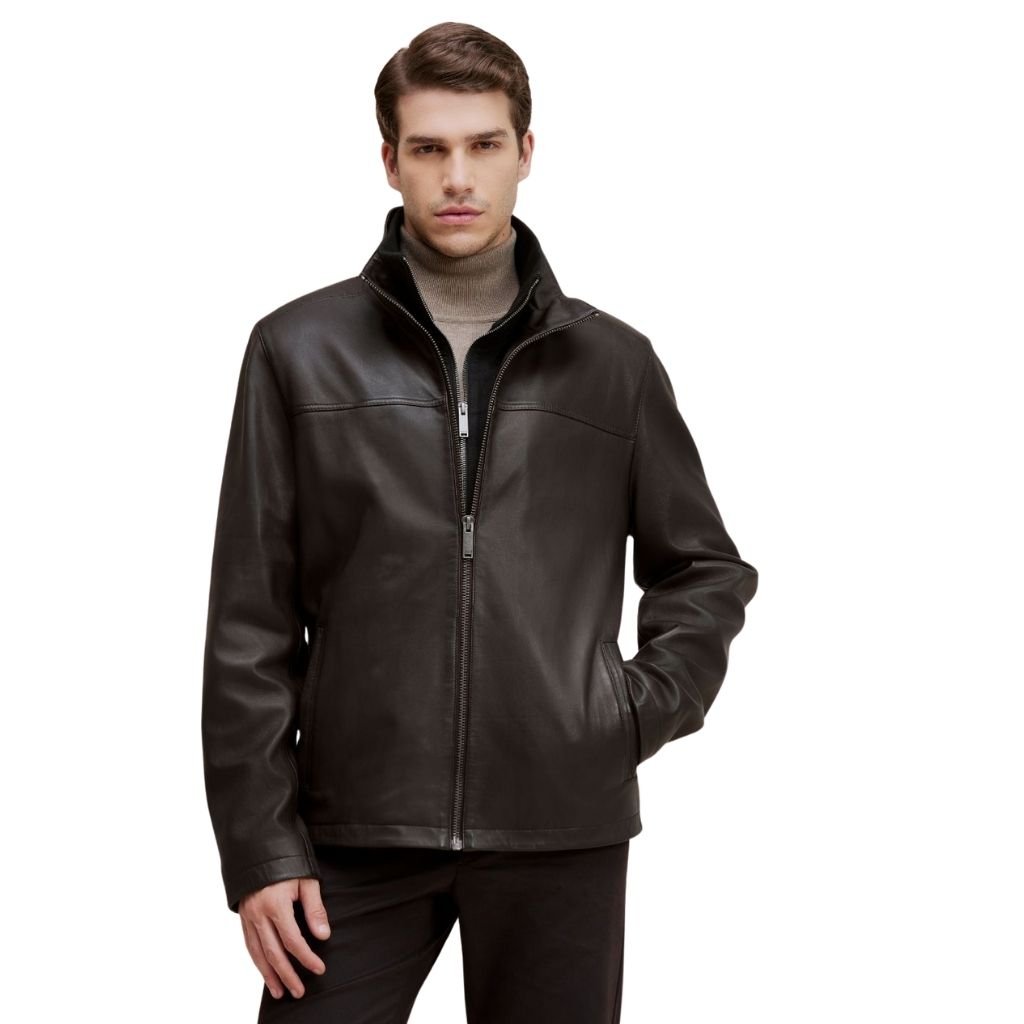 Modern ZIP Up Leather Jacket: Sleek Style for Everyday Wear 7 A man wearing a dark brown leather zip-up jacket, standing with one hand in a pocket, against a plain light background.