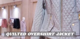Why Quilted Overshirt Jackets Are the Perfect Everyday Layer A quilted overshirt jacket in a light gray color with visible zipper and pocket details, displayed in a store setting.