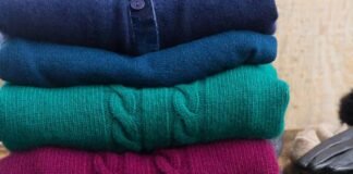 Lambswool Clothing: Comfort, Durability, and Style Explained Stack of folded wool sweaters in rich winter colors, showcasing soft texture and cozy knit fabric.