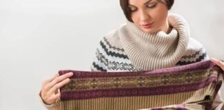 Does Shetland Wool Itch? Comfort, Feel & Facts Explained Now Woman examining the fabric of a patterned wool sweater, checking its texture and quality.Does Shetland Wool Itch?