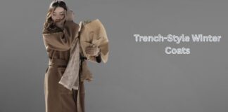 Trench-Style Winter Coats: Timeless Warmth and Style Guide Woman wearing a beige trench-style winter coat with a scarf, holding a bouquet against a minimalist grey background.Trench-Style Winter Coats