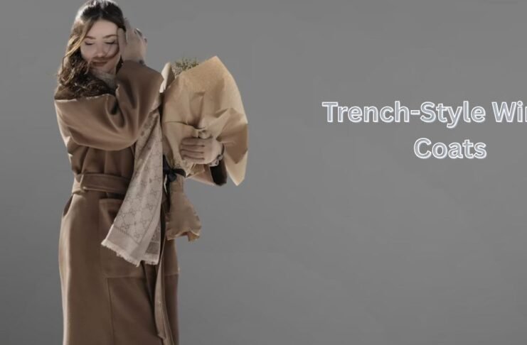 Woman wearing a beige trench-style winter coat with a scarf, holding a bouquet against a minimalist grey background.Trench-Style Winter Coats