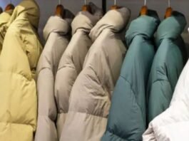 Close-up of a person wearing a red quilted jacket with one hand tucked into the pocket.Why Oversized Padded Jackets