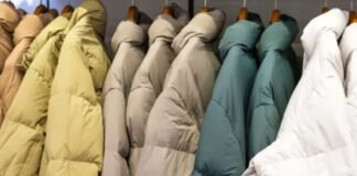 Why Oversized Padded Jackets Are Trending This Winter Season Close-up of a person wearing a red quilted jacket with one hand tucked into the pocket.Why Oversized Padded Jackets