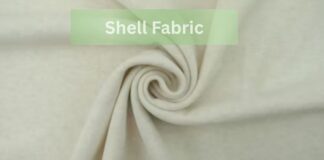 Does Shell Fabric Affect Warmth and Protection in Apparel? A close-up of light beige shell fabric arranged in a swirl pattern with the text “Shell Fabric” displayed in a green box at the top.Does Shell Fabric