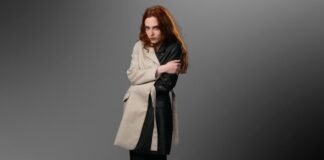 Is a Long Parka Coat Worth It? Everything You Need to Know Woman wearing a beige and black color-block coat with leather sleeve against a grey background.Is a Long Parka Coat Worth It?