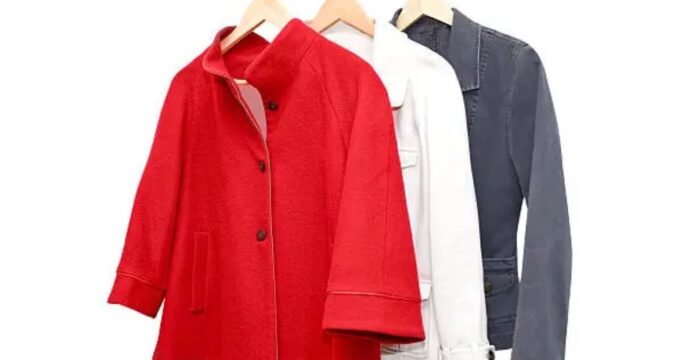 Three women’s jackets hanging on wooden hangers, featuring a bright red coat in front, followed by a white jacket and a dark grey jacket against a plain white background. Boiled Wool Jacket
