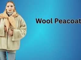 The Wool Peacoat Comeback:Woman wearing a beige wool peacoat with a scarf, standing against a blue gradient background.
