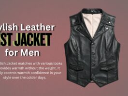 Black leather men’s vest jacket with a beige inner lining, front pockets, and snap buttons, displayed against a muted brown background.