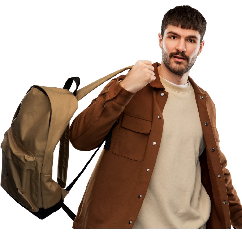 Wool Overshirt Jackets: Warmth and Style for Every Season 20 A man with a trimmed beard wearing a brown jacket over a beige shirt, carrying a large tan backpack over his shoulder and looking toward the camera.