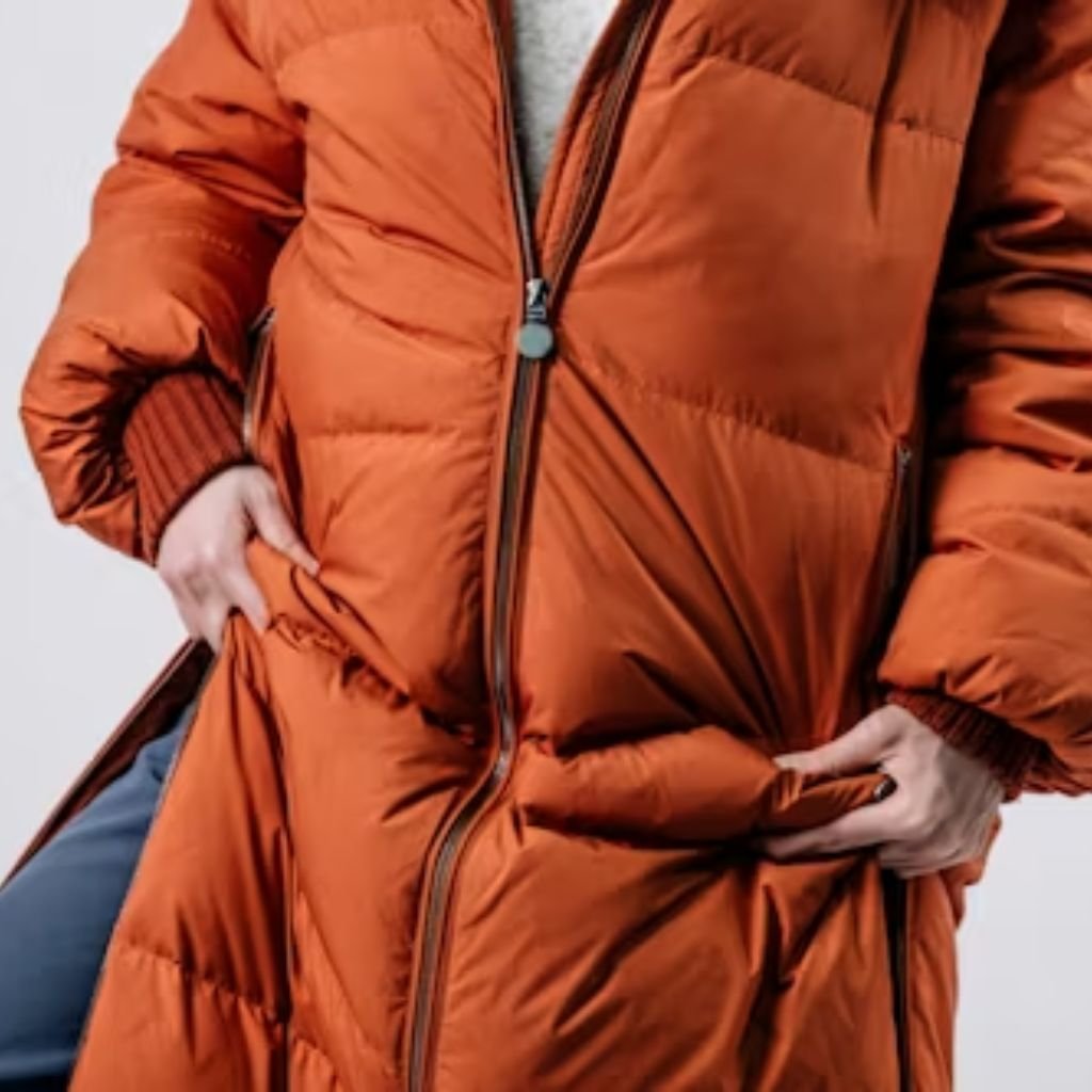 Neutral-toned sweaters and clothing hanging neatly on a wardrobe rack, showcasing soft knit and textured fabrics.Lightweight Down Jacket