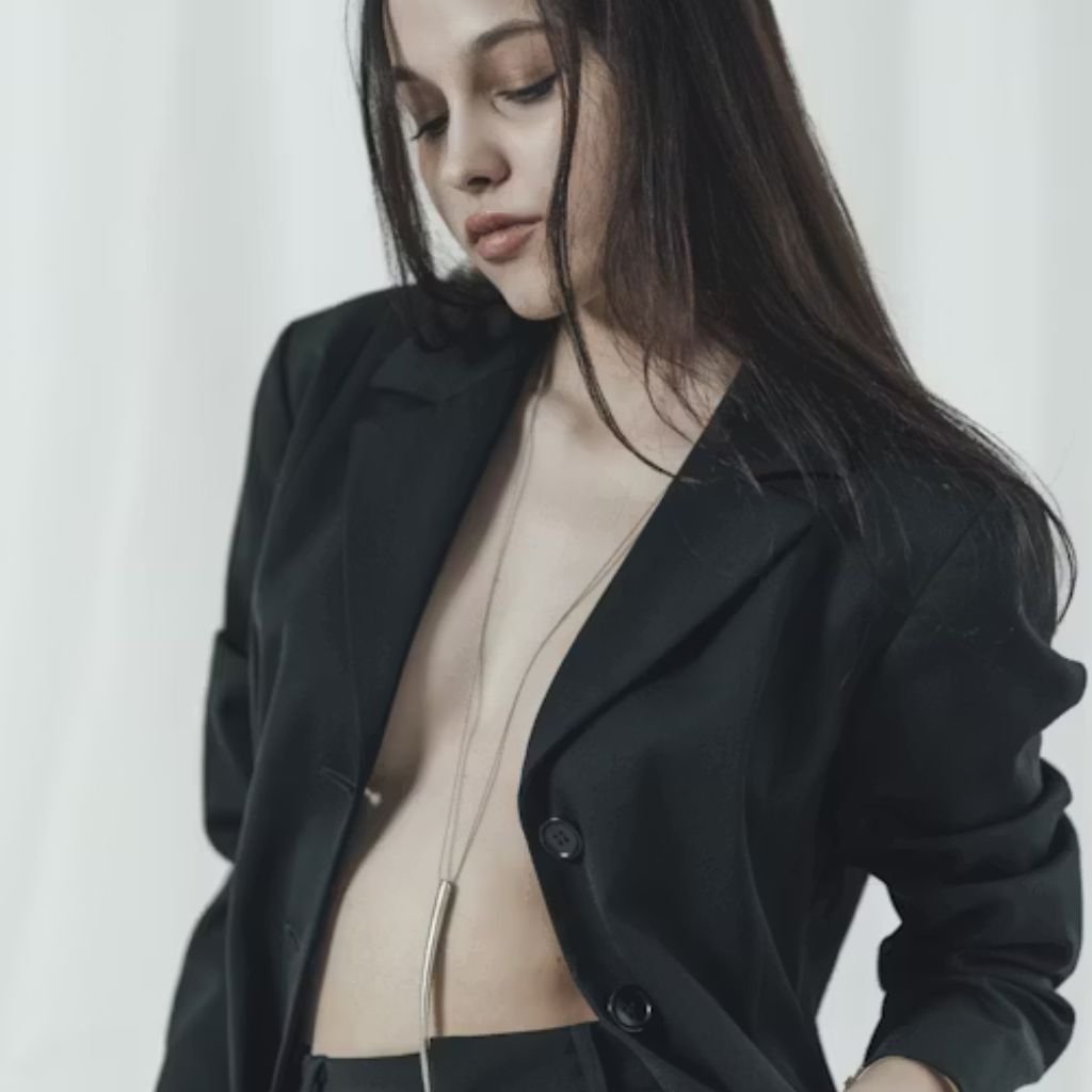 A man walking forward in a tailored blue double-breasted suit with a light pink tie and tan shoes against a plain light background.Double-Breasted Wool Jackets: