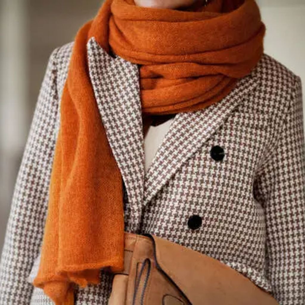 A man walking forward in a tailored blue double-breasted suit with a light pink tie and tan shoes against a plain light background.Double-Breasted Wool Jackets: