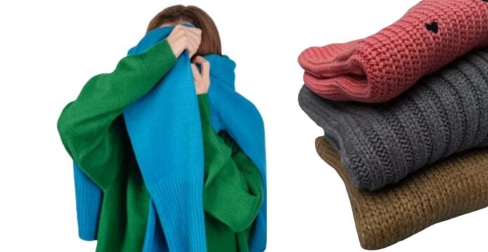 A person in a green sweater playfully covering their face with a bright blue knitted scarf, alongside a neatly folded stack of cozy knitwear in pink, gray, and brown, illustrating warmth, comfort, and the question “does polyester make you sweat.”cozy winter outfits