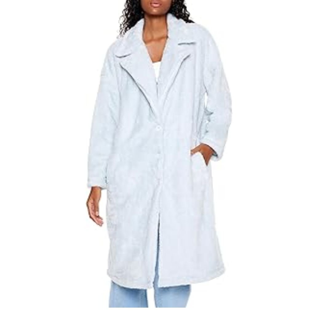 A woman wearing a brown double-breasted wool coat with a wide collar, styled with patterned black leggings.Teddy Coats