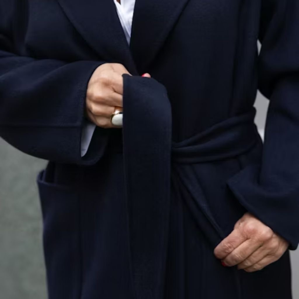 Two people standing close together outdoors, seen from behind, wearing patterned and pink shirts with trees in the background.Double-Breasted Wool Jackets: