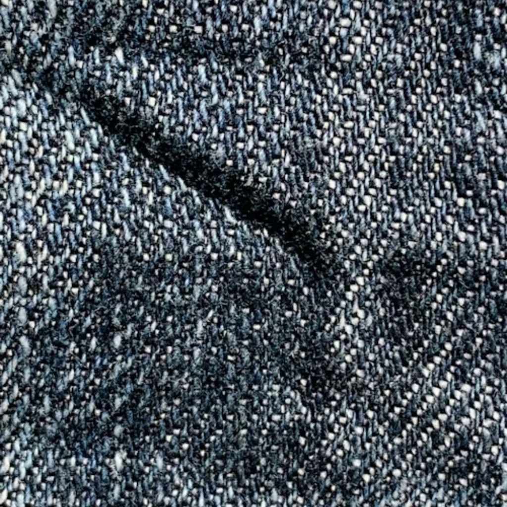 Close-up of textured woven fabric in dark blue and gray tones.Is Herringbone Wool Worth It?