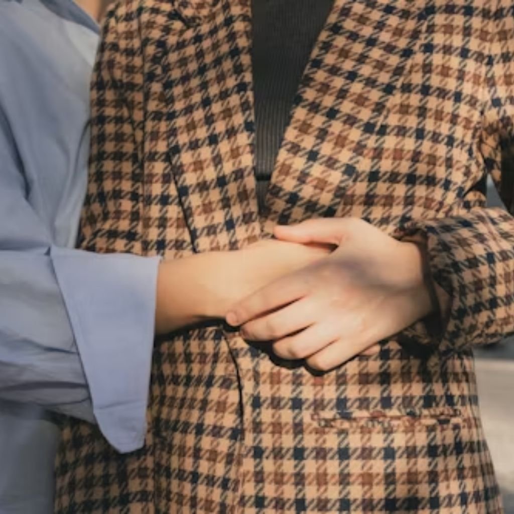 A man walking forward in a tailored blue double-breasted suit with a light pink tie and tan shoes against a plain light background.The image shows a man walking toward the camera against a clean, light-colored background. He is wearing a tailored blue double-breasted suit with a structured jacket and matching trousers, paired with a white dress shirt and a light pink tie. His shoes are tan, adding contrast to the outfit. His dark hair is neatly styled, and his posture and forward motion give the image a polished, confident, and professional feel.