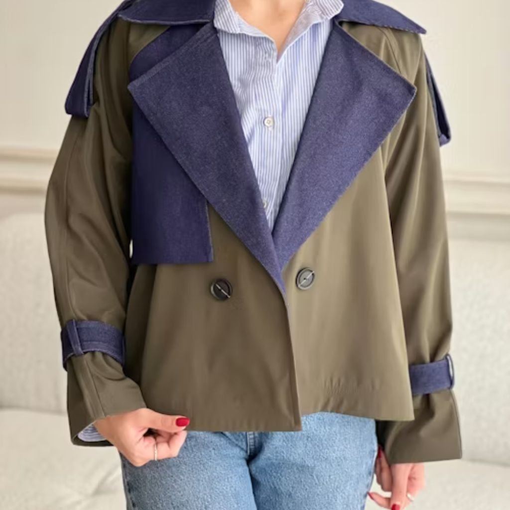 Woman wearing a beige and black color-block coat with leather sleeve against a grey background.Lightweight Down Jacket