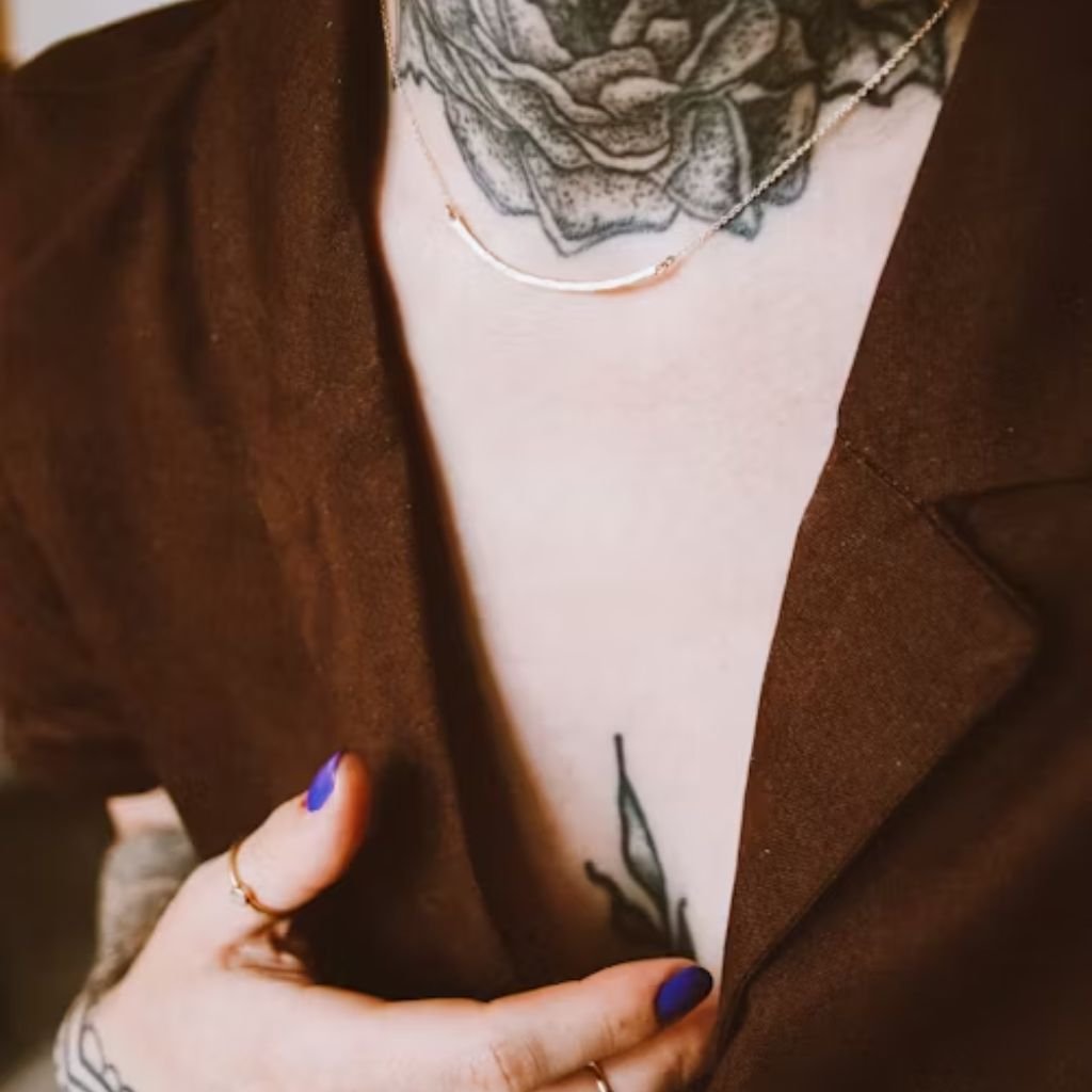 A person wearing a green double-breasted suit with a patterned tie and pocket square, standing outdoors among trees.Double-Breasted Wool Jackets: