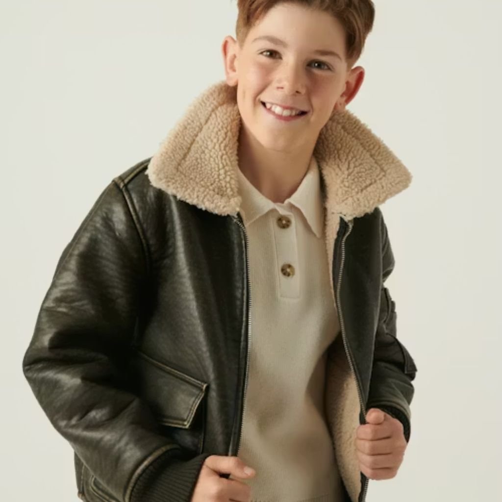 Woman wearing a beige oversized button-up jacket with a textured fabric and relaxed fit, styled casually against a white background.Lightweight Down Jacket