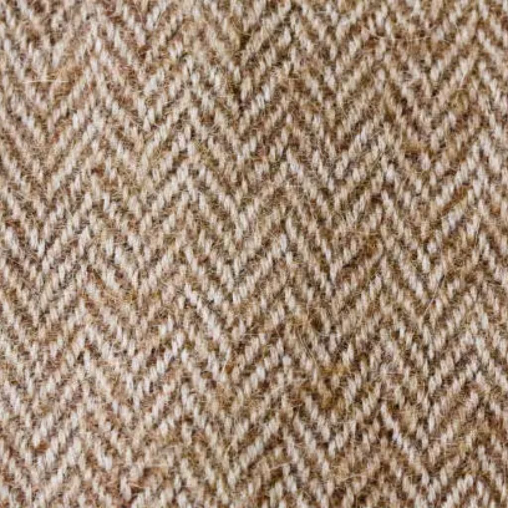 Close-up view of beige herringbone wool fabric with a classic zigzag weave pattern.Is Herringbone Wool Worth It?