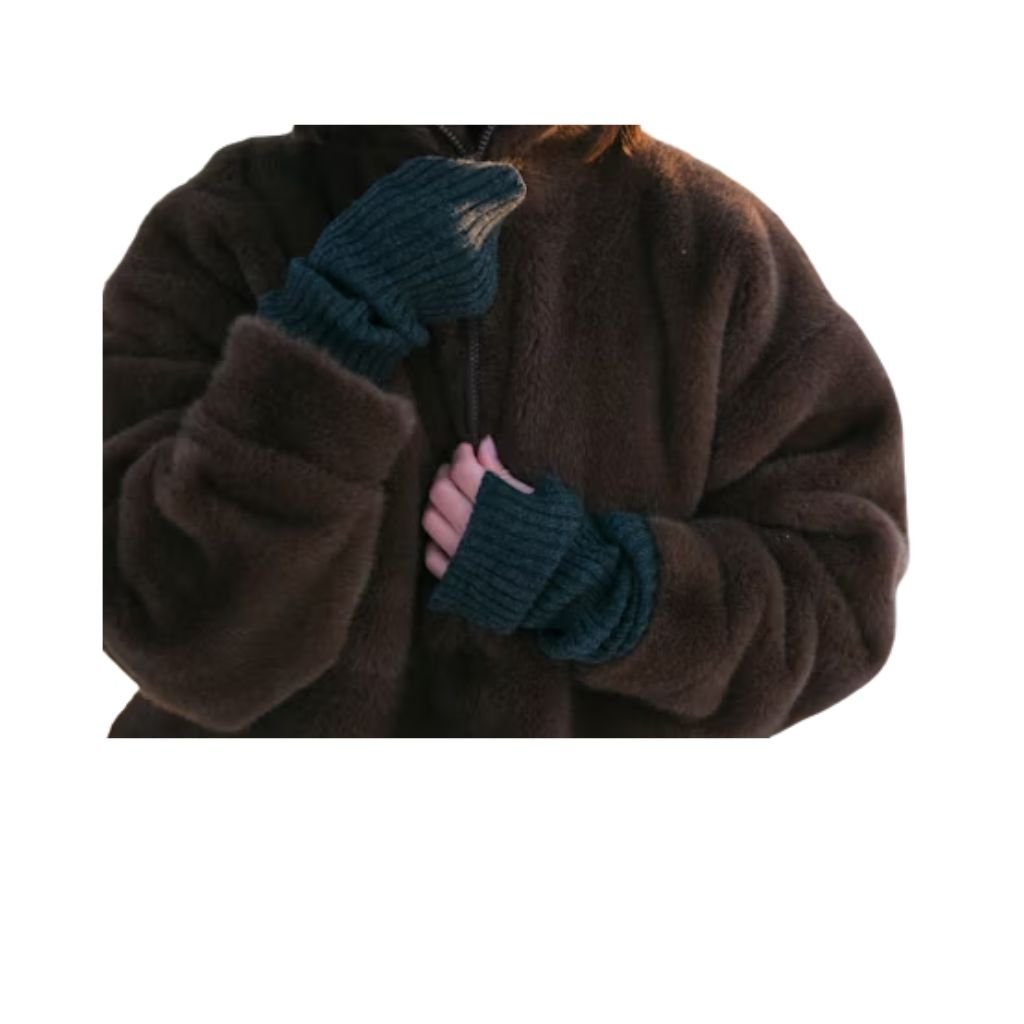 A woman wearing a brown double-breasted wool coat with a wide collar, styled with patterned black leggings.Teddy Coats