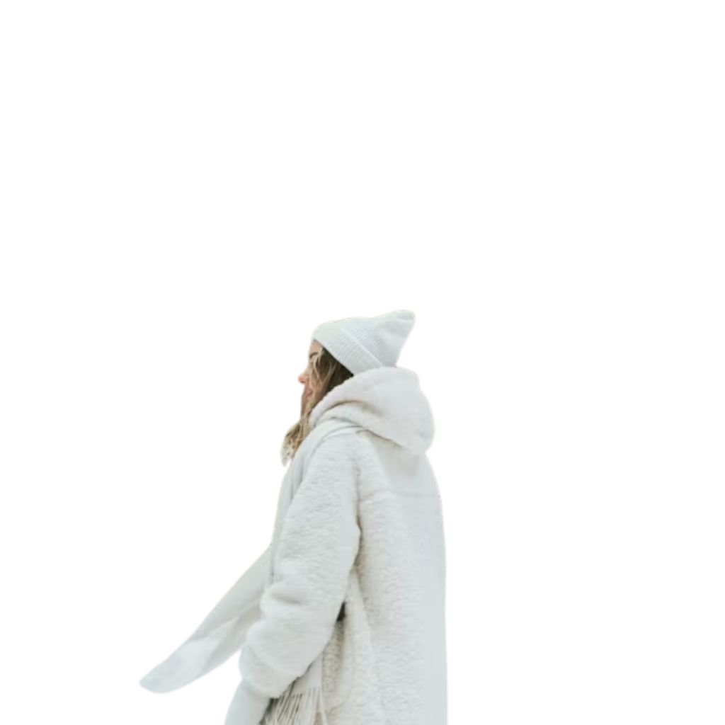 Person wearing a yellow puffer jacket, patterned winter sweater, and knit balaclava, posing against a blue gradient background.Monochrome winter outfits