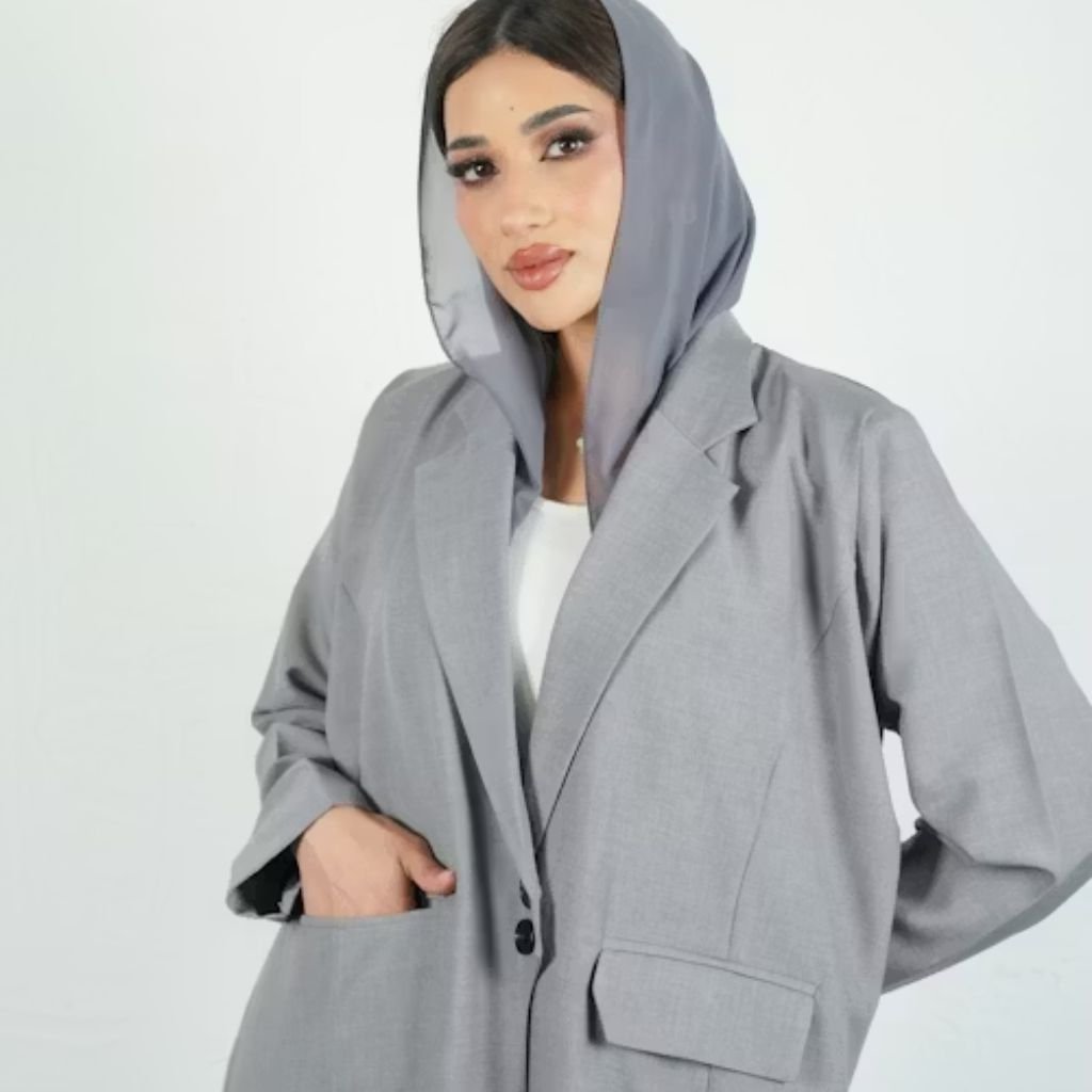 A close-up view of several leather jackets hanging side by side on a clothing rack, displaying various shades of brown and black.Lightweight Down Jacket