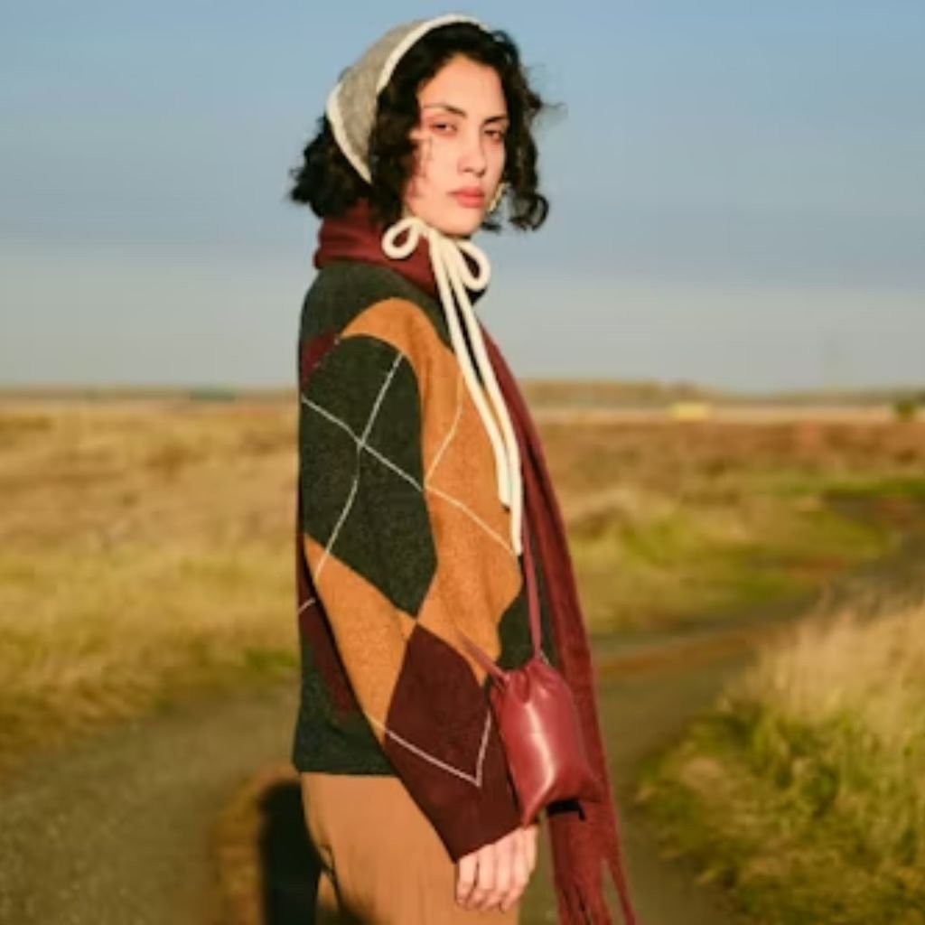 Dark gray crewneck knit sweater with long sleeves, displayed on a plain white background.Does Shetland Wool Itch?