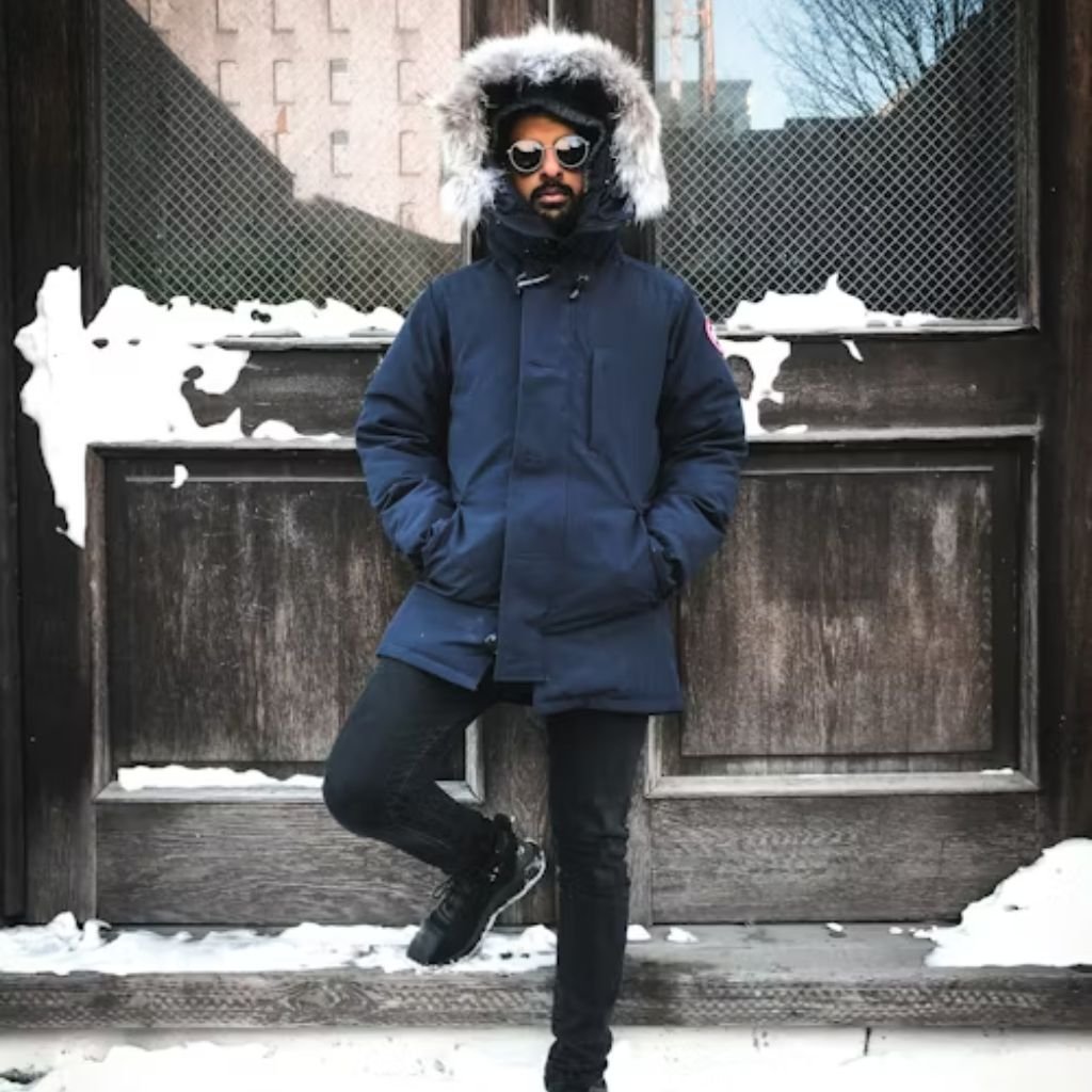 A beige double-breasted trench coat with a belt, shoulder epaulettes, and long sleeves displayed on a white background.Belted Winter Coats