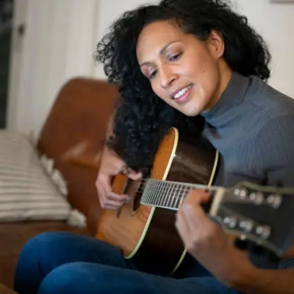 A woman wearing a light gray oversized mock-neck sweatshirt paired with black pants, posing with one hand tucked into the hem of the sweatshirt.Why Mock neck turtlenecks