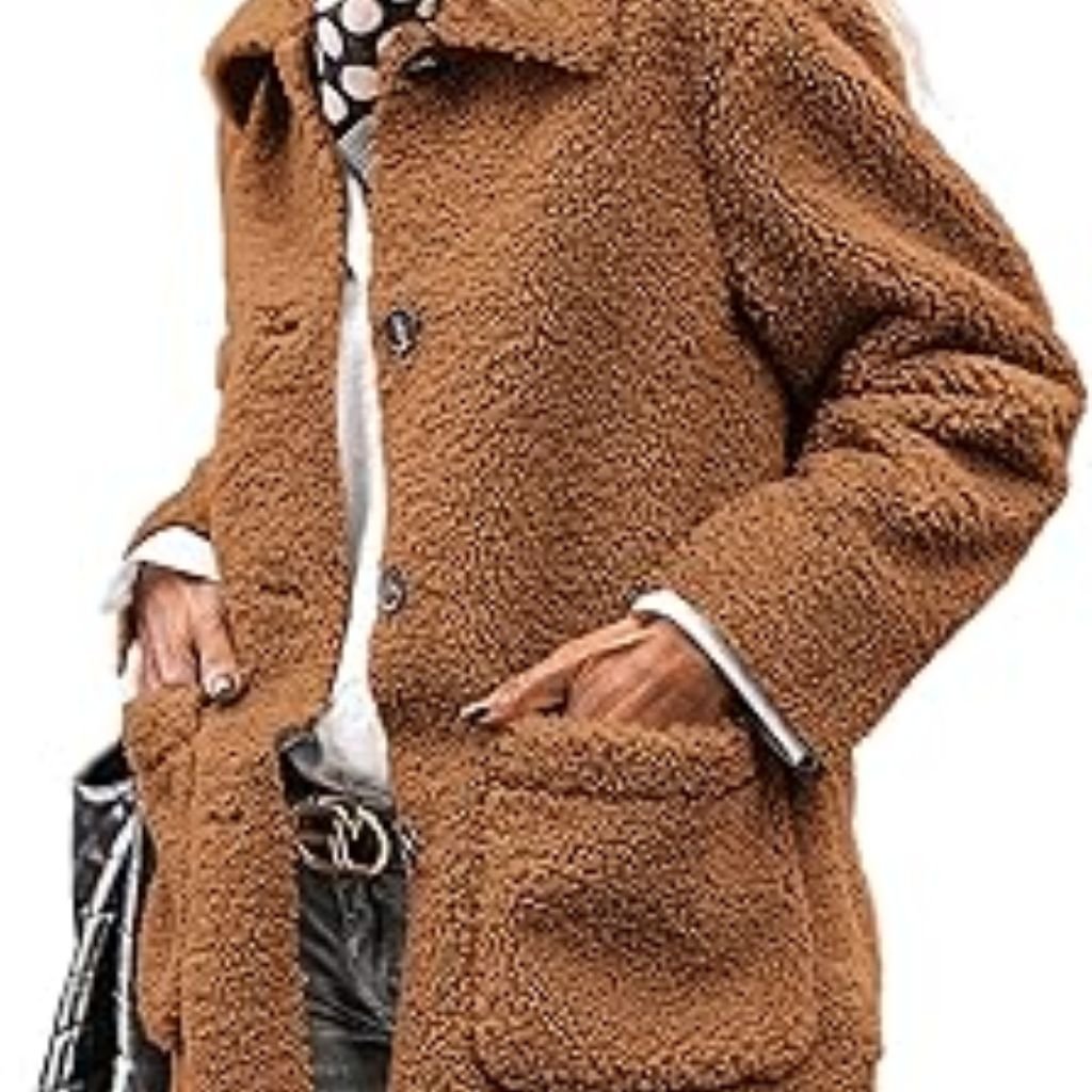 A woman wearing a brown double-breasted wool coat with a wide collar, styled with patterned black leggings.Teddy Coats