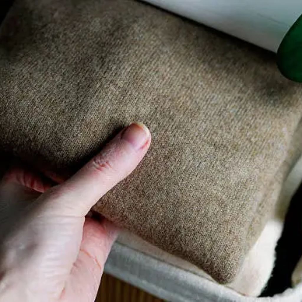 Stacked knitted fabric layers in soft pastel colors, including light blue and pale pink, showing textured yarn details.Does Shetland Wool Itch?