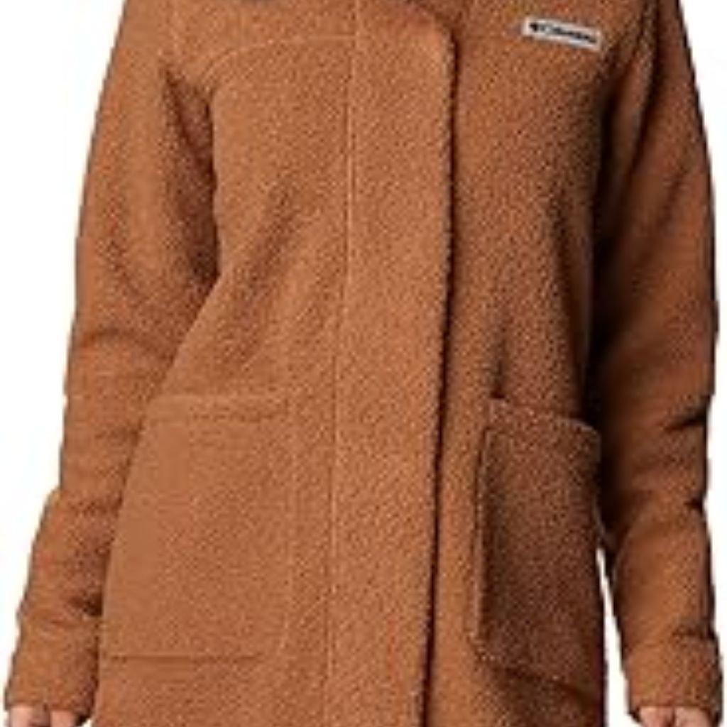 A woman wearing a brown double-breasted wool coat with a wide collar, styled with patterned black leggings.Teddy Coats