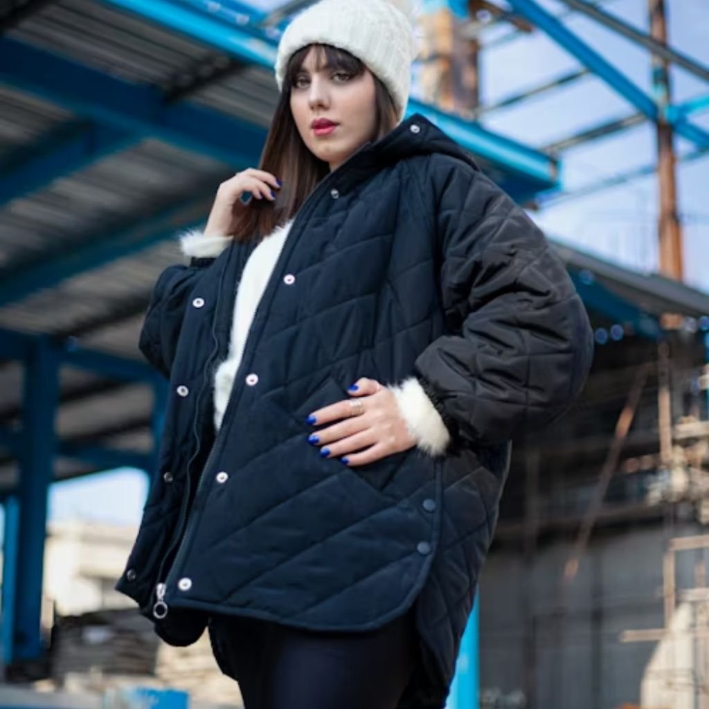 Person wearing a rust-colored jacket and holding a knitted scarf over a warm sweater in a cozy winter outfit.Lightweight Down Jacket