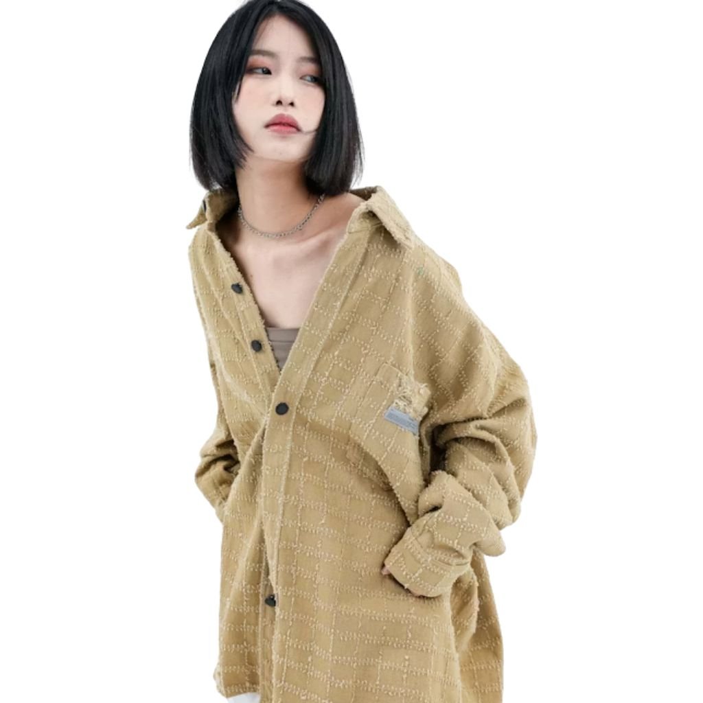 Woman wearing a beige oversized button-up jacket with a textured fabric and relaxed fit, styled casually against a white background.Boiled Wool Jacket